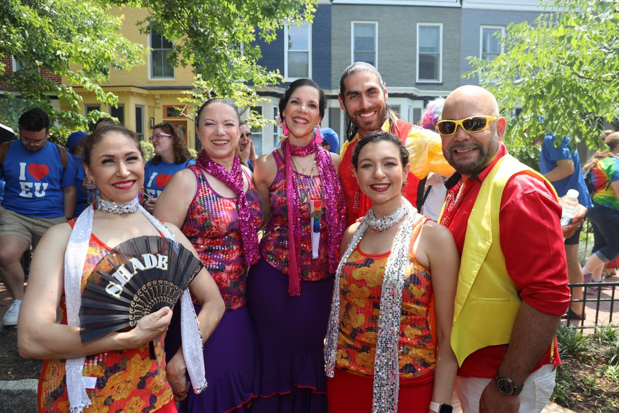 Four female and two male flamenco dancers pose for the camera.