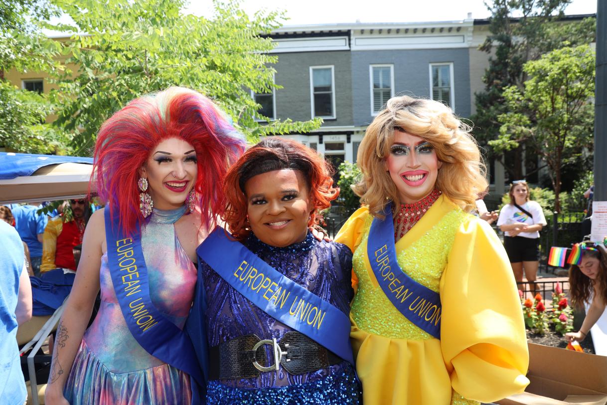 Three drag queens pose for the camera.