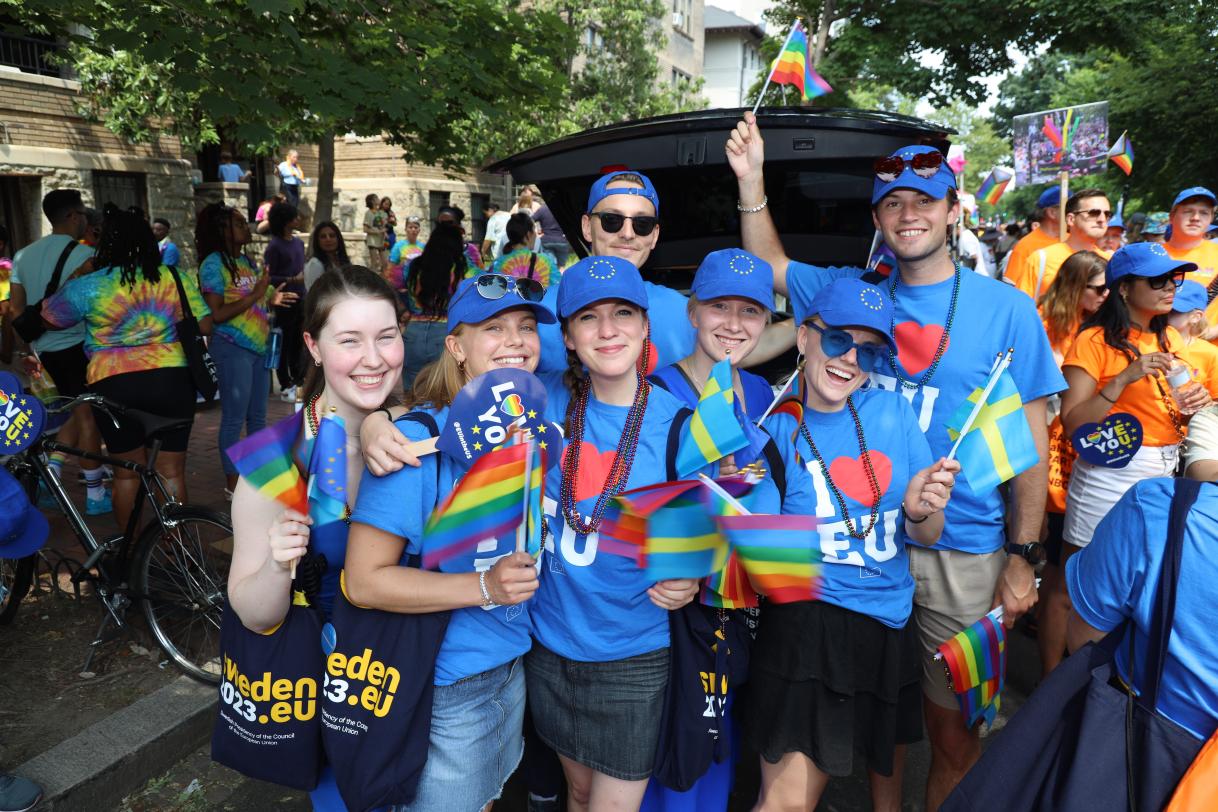 People in "I Heart EU" T-shirts pose for the camera.