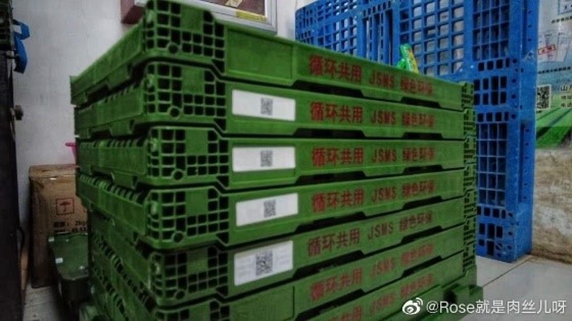 Stacked green plastic pallets