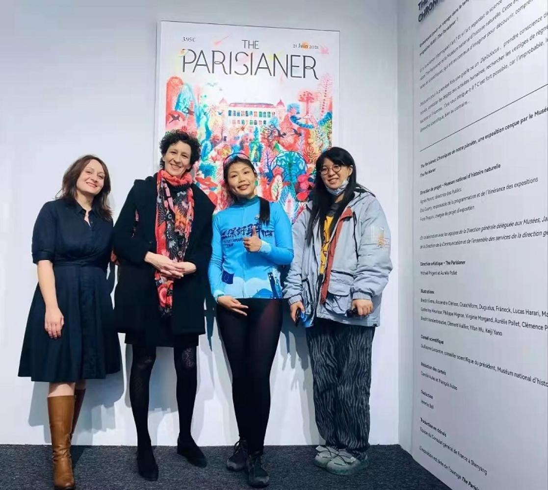 Four women posing, one of them dressed as a cyclist