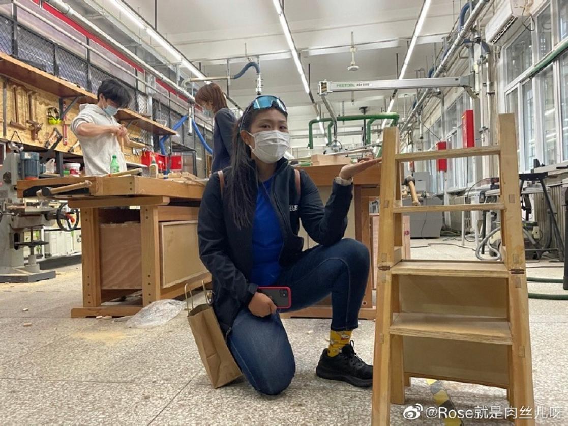 Woman posing with a wooden ladder