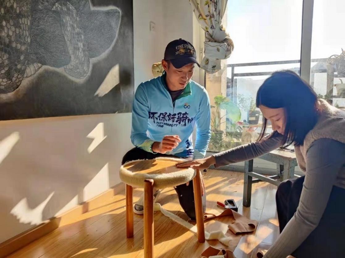 Man and woman fixing a stool