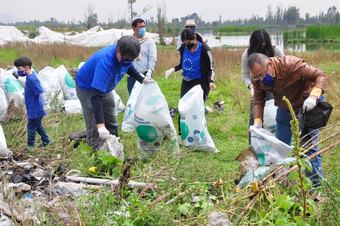 Group of people with blue shirts working