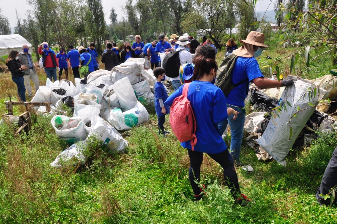 Group of people with blue shirts working