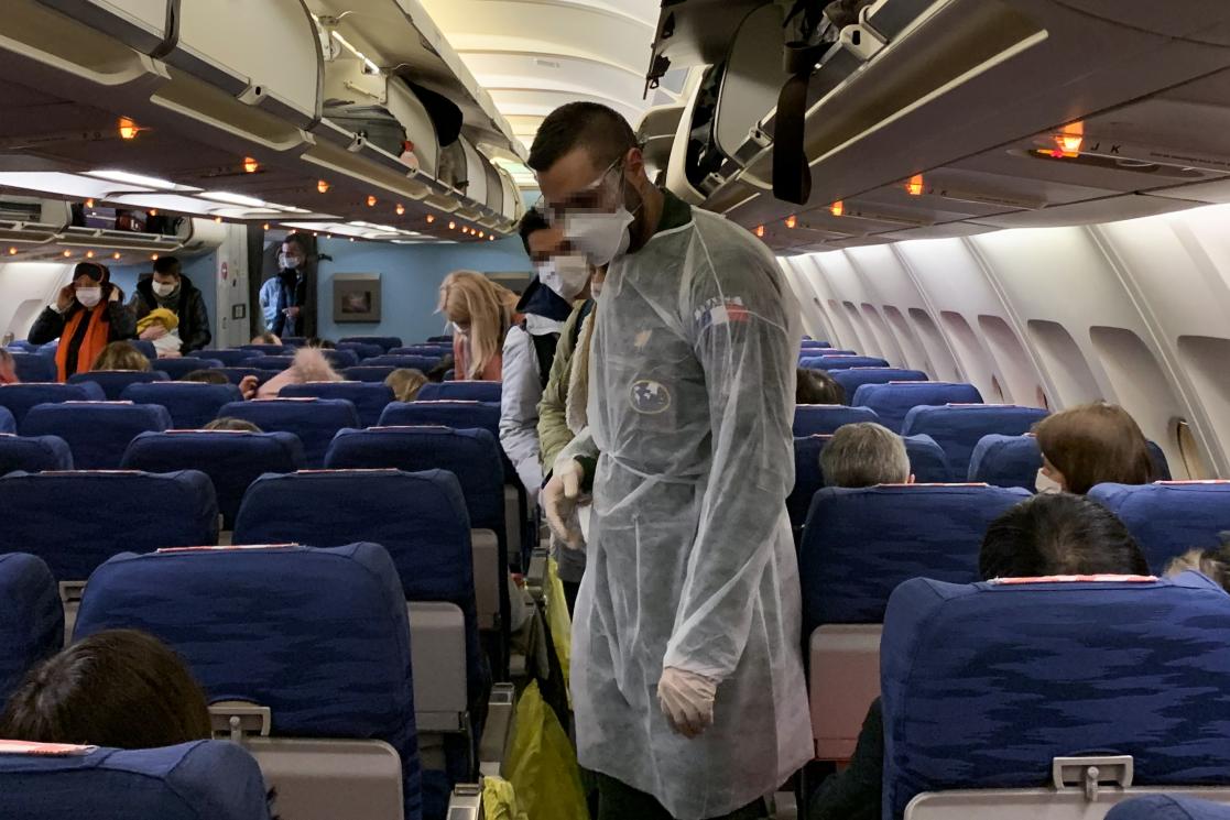 people with masks on a plane