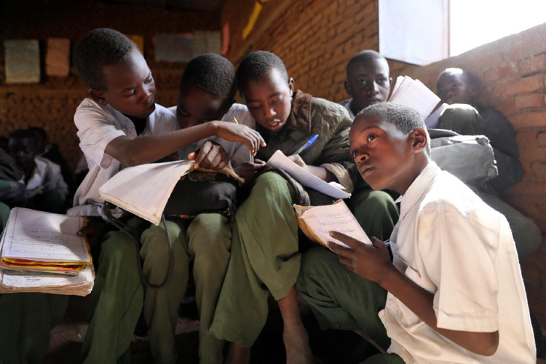 Children in a school doing homework in notebooks