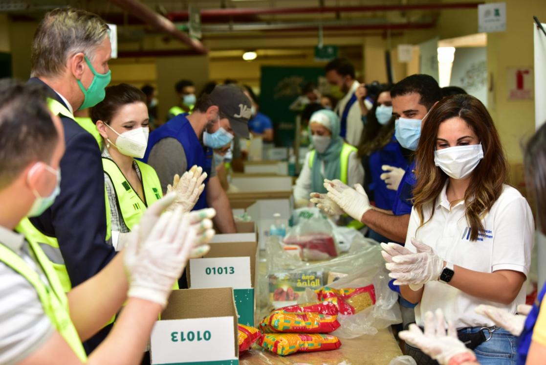 People filling boxes with food