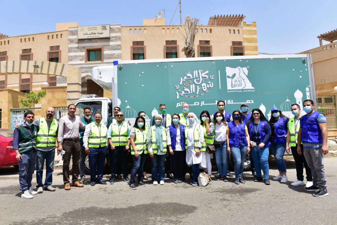 Group of people with a truck in the back