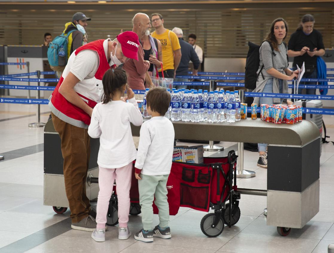 Children talking to airport staff