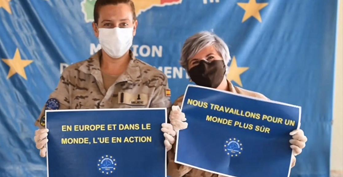 Two soldiers holding posters