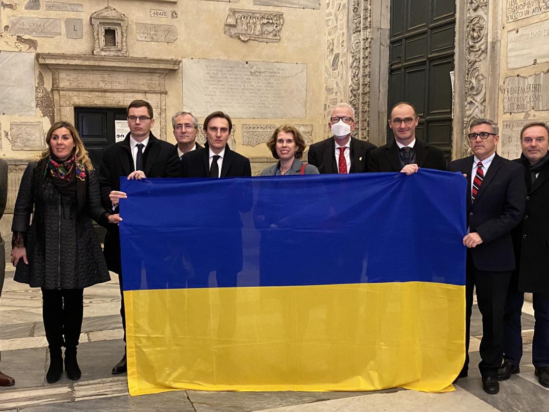 Group of people carrying the Ukrainian flag