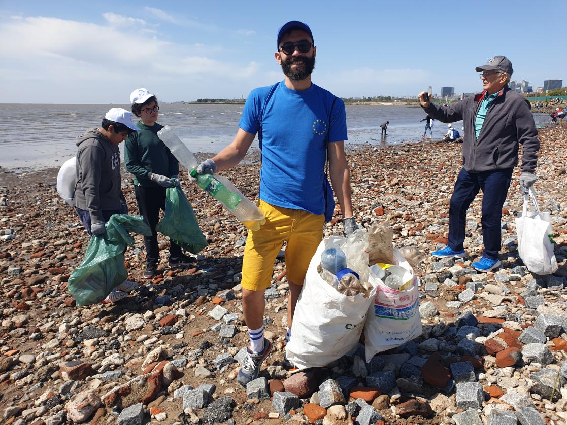 Man picking up litter on the beach