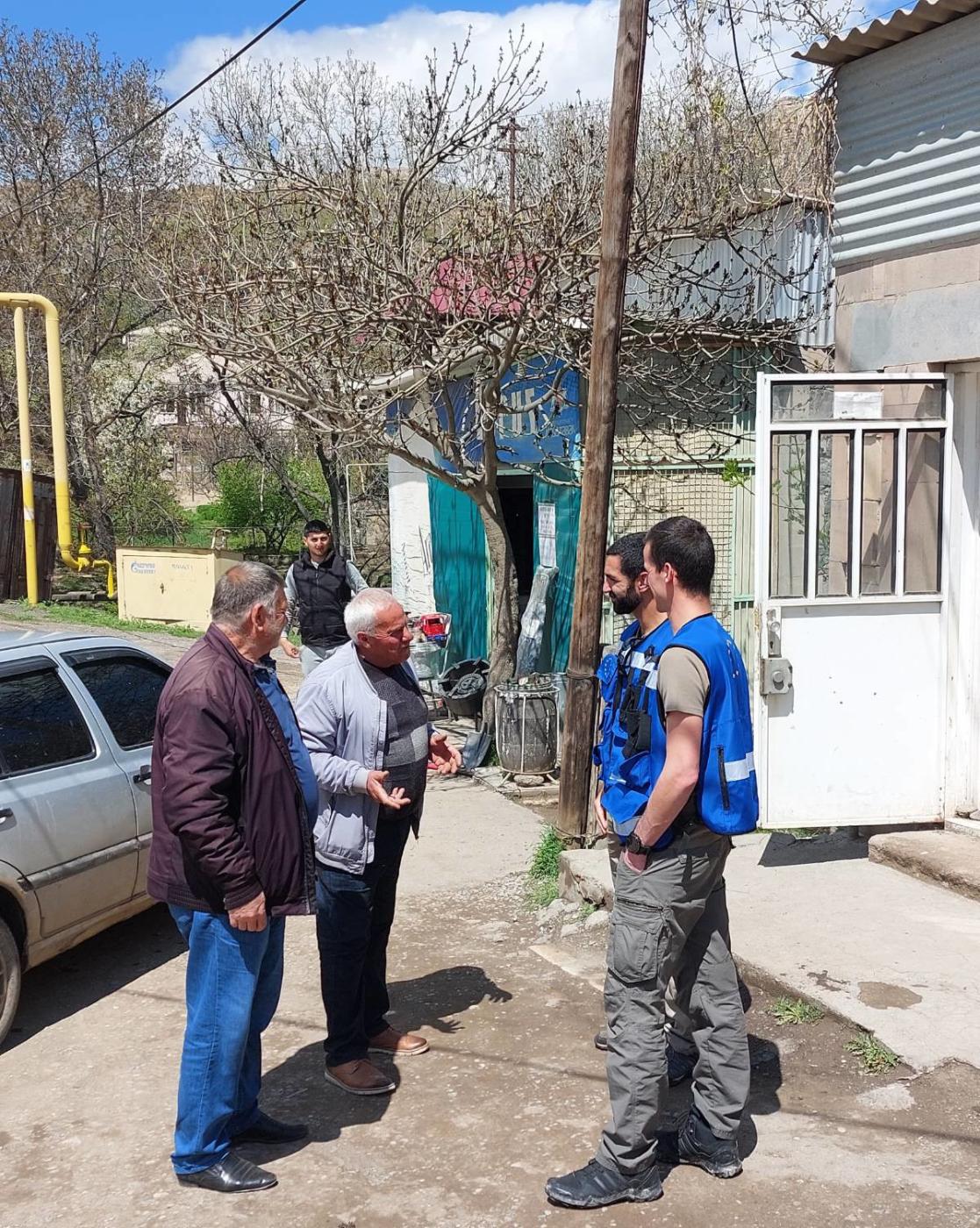 Four men talking in the street