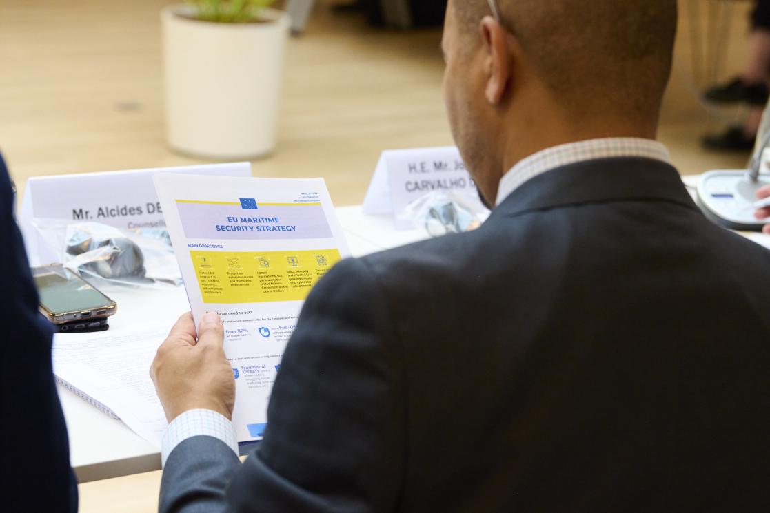 A delegate looks at a document called EU Maritime Security Strategy.