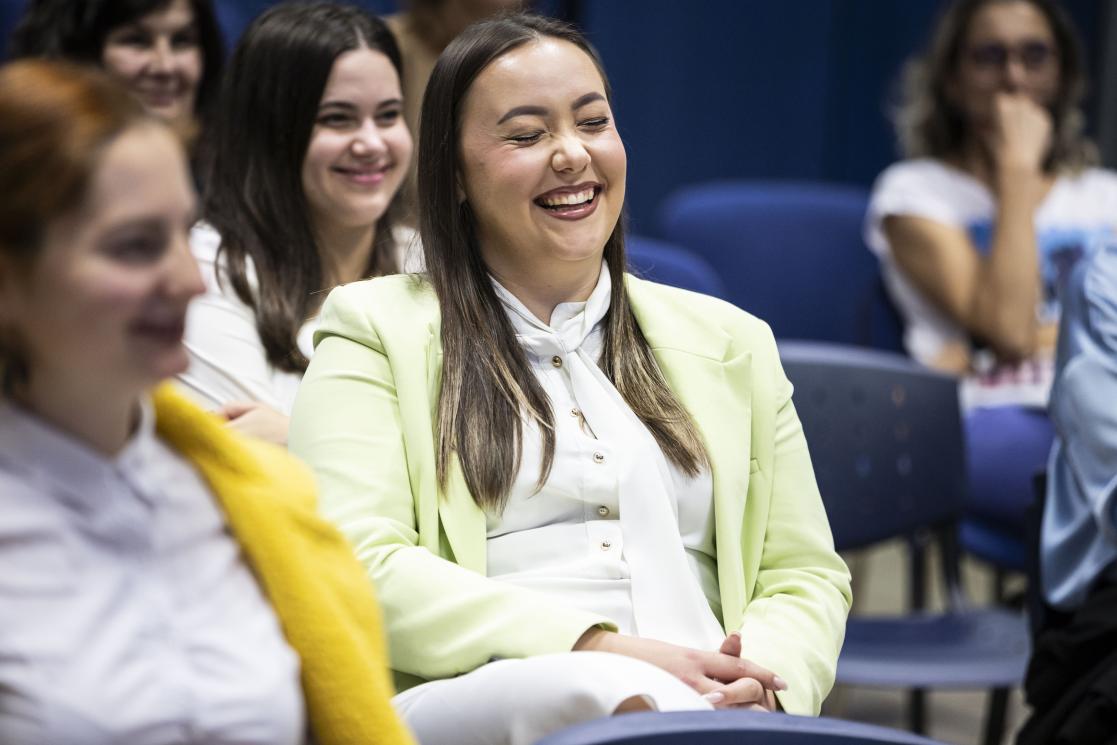 Member of the audience sitting and smiling