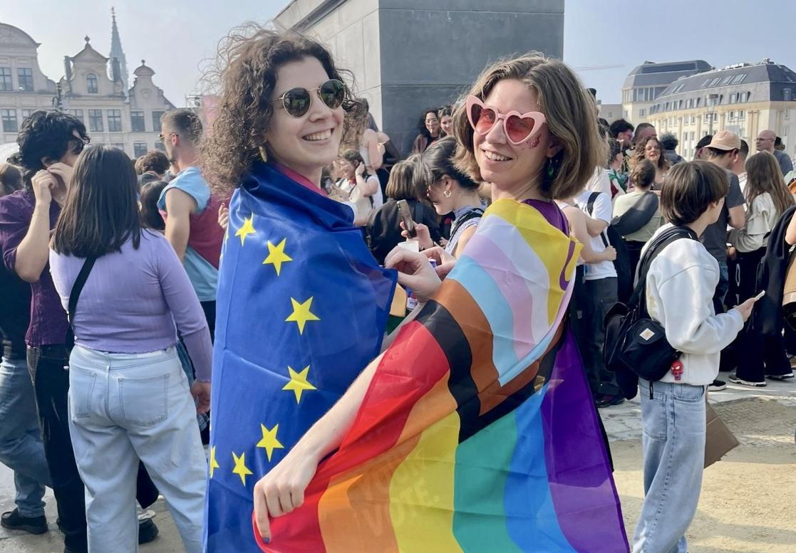 Two girls with Progress Pride and EU Flag