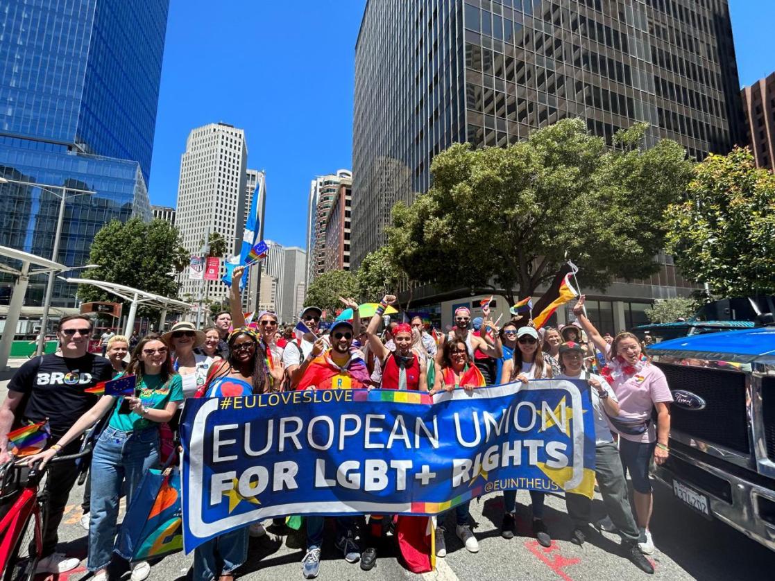 A large group of people holding a long banner reading "European Union for LGBT+ Rights"