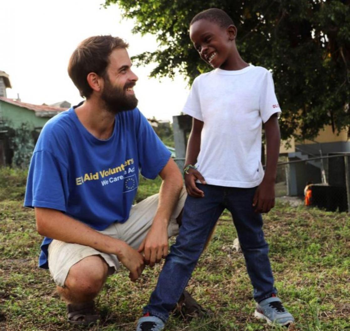 EU Aid Volunteer with child