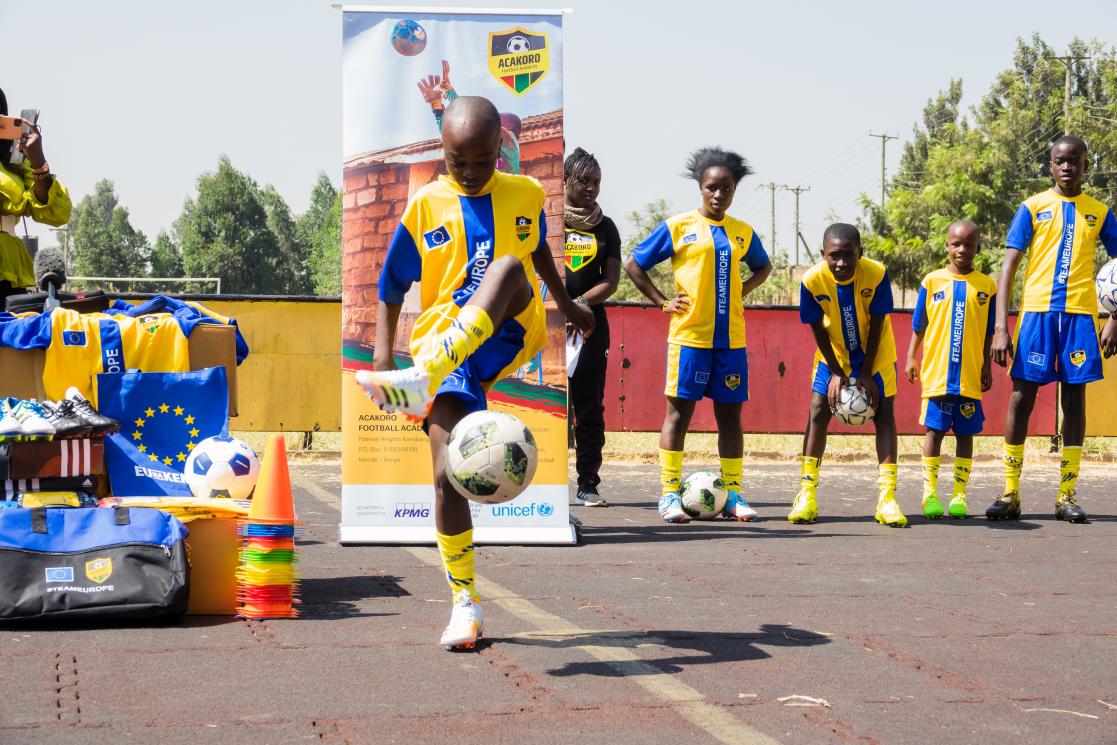 Kids in Kenya playing football.