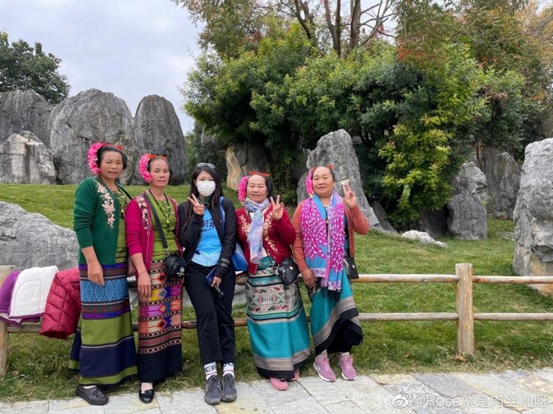 Five women posing in a park