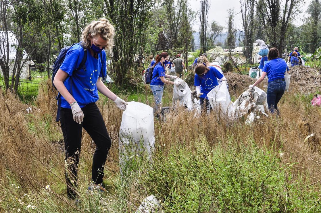 Group of people with blue shirts working