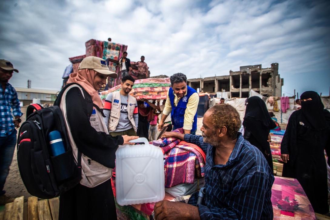 © IOM staff, and implementing partner in a joyful moment with Abdulhakem.