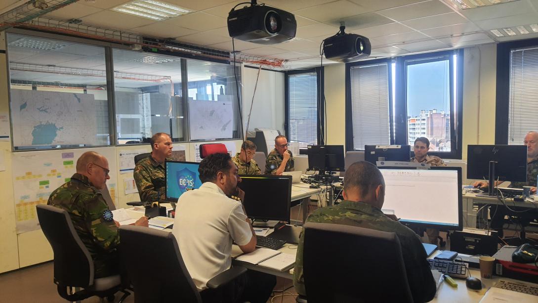 people sitting at desks with computers