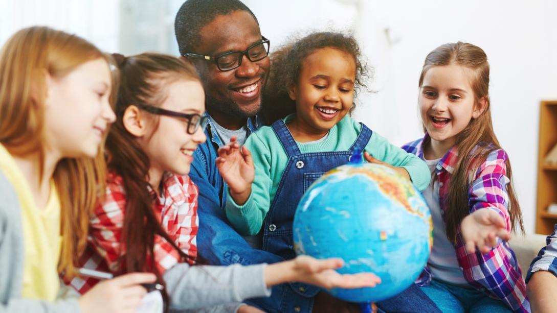 Dad and girls with globe