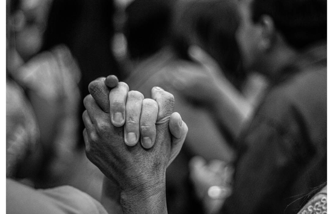 Black and white picture of two people holding hands