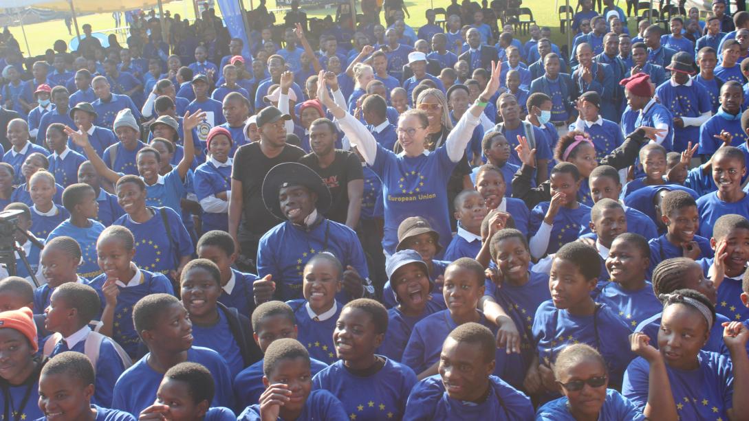 Large group of school children wearing EU sweaters.