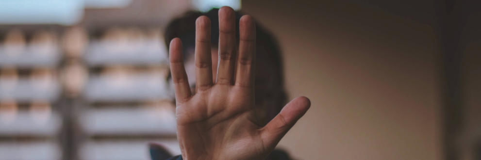 Photo of a man holding a stop hand