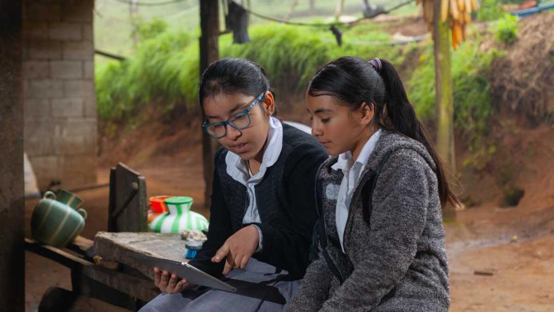 Two students looking at a tablet