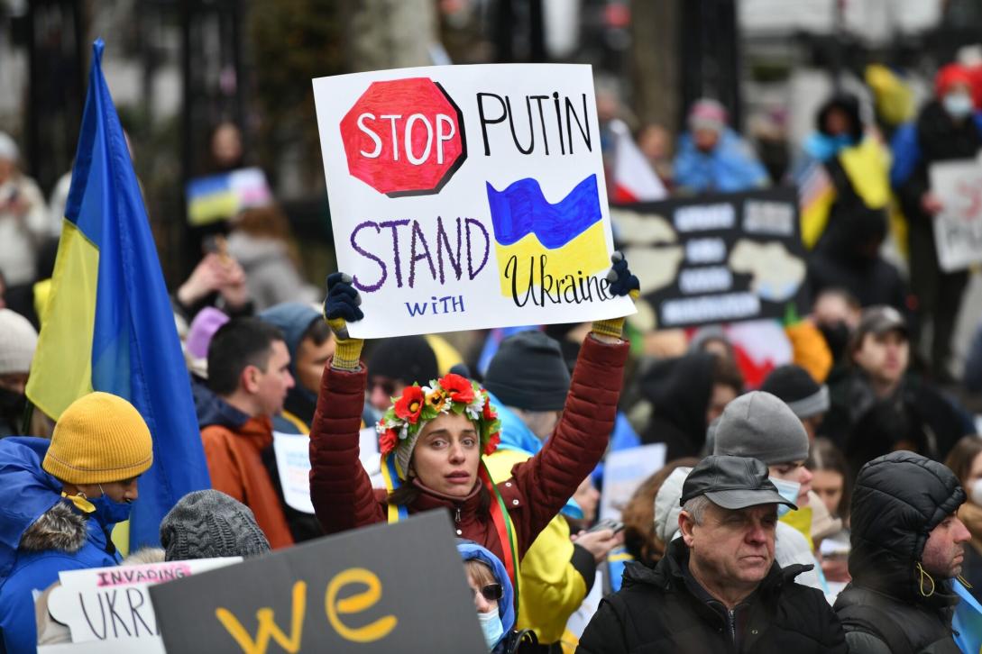 A protester with a Stop Putin, Stand with Ukraine banner.