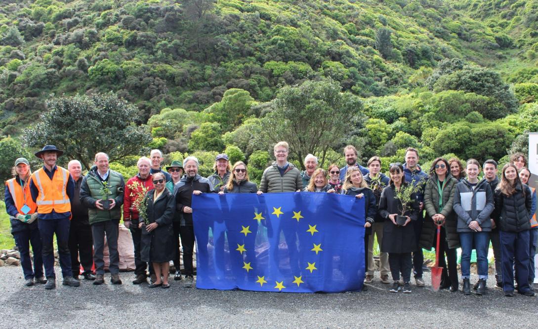 tree planting event participants holding an EU flag