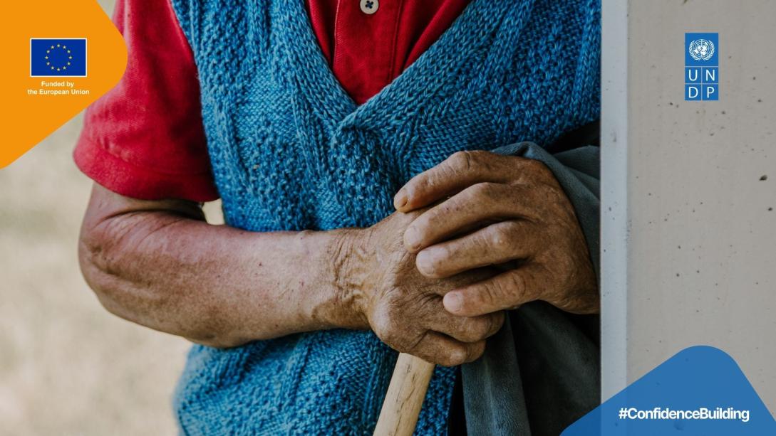 Hands holding wooden stick