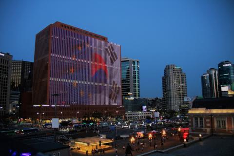 EU Delegation to Korea building is lit with EU and Korea flags. 