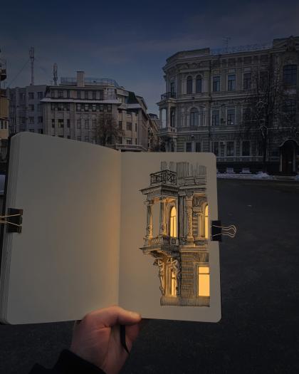 Artwork from artist Nikita representing an illuminated builidng with the real buildign in the background