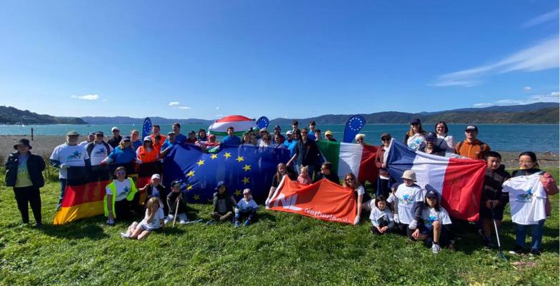 A group of EU delegation and EU Member State Embassies' staff on a beach