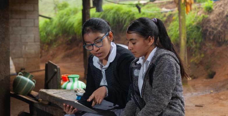 Two students looking at a tablet