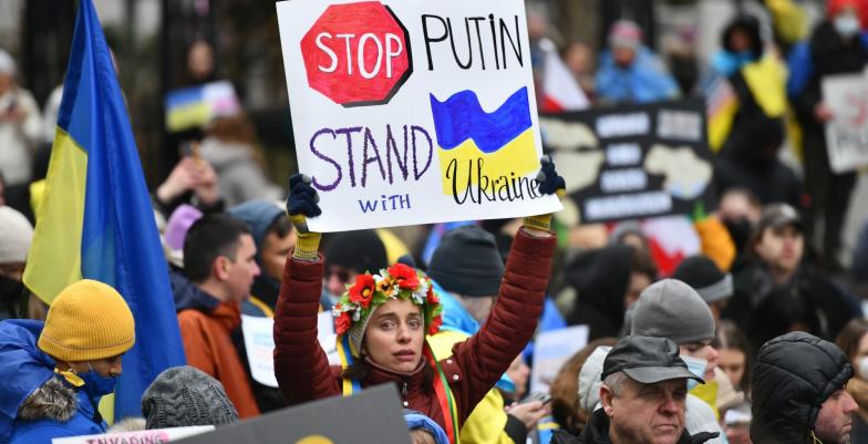 A protester with a Stop Putin, Stand with Ukraine banner.